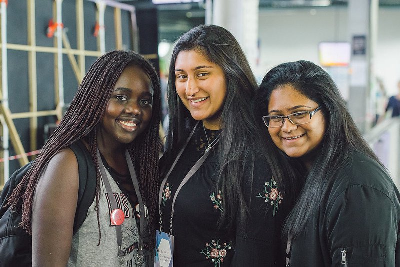 A photograph of three participants standing together and smiling at MozFest 2017