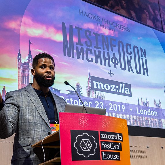 A speaker on stage at MisInfoCon, an event held as part of MisInfoCon held at MozFest House