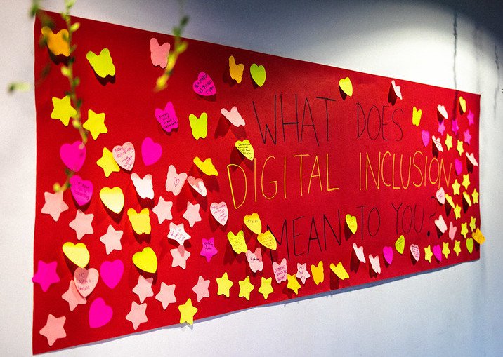 Photo by Connor Ballard-Pateman of giant poster asking What does Digital Inclusion mean to you?