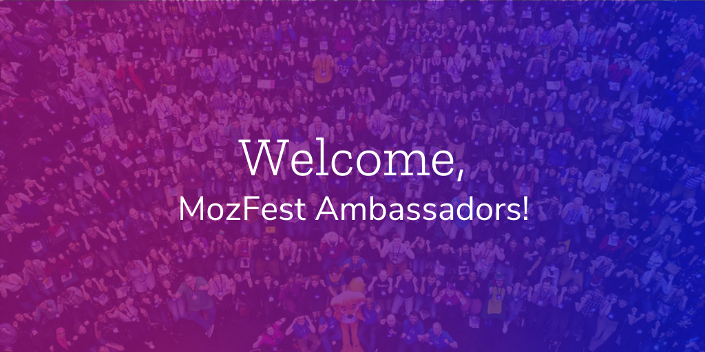 "Welcome MozFest Ambassadors!" in white text over a purple and blue gradient background, which includes a group photo from a past event.