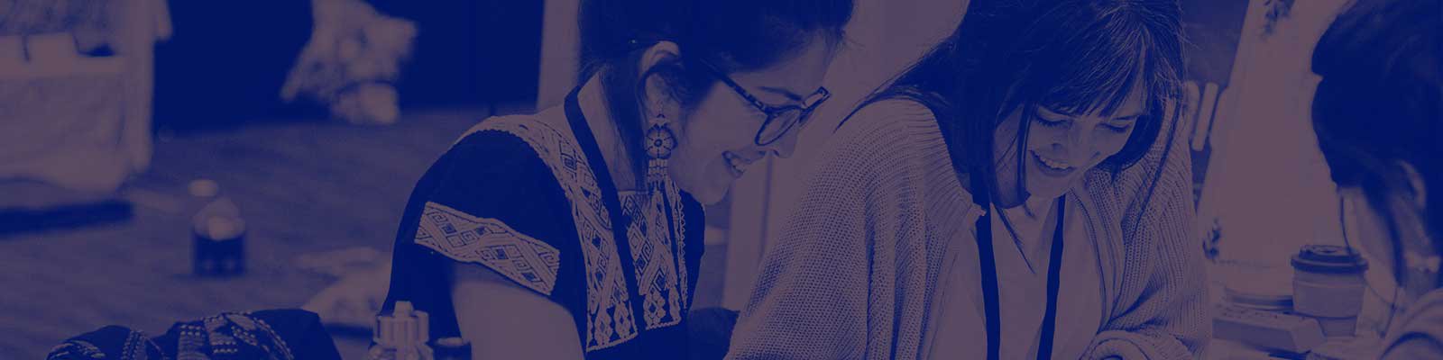 Two people sat at a table crafting during a session a MozFest