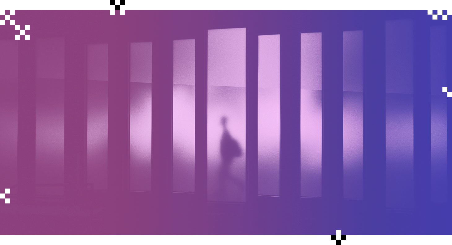 silhouette of a person walking behind a panel