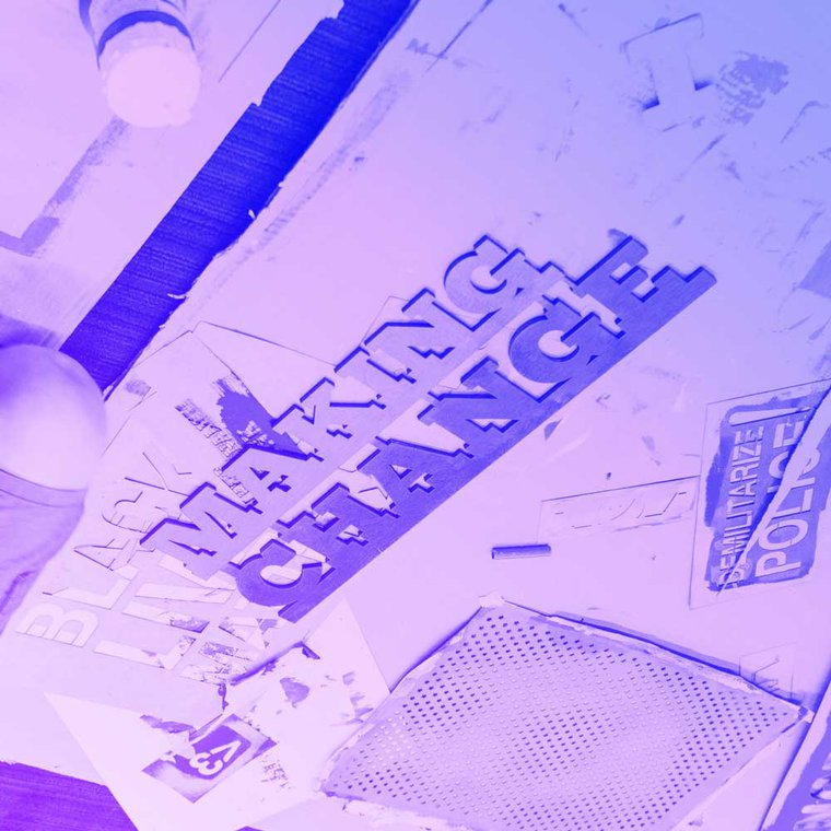 A sign making session at MozFest, showing different stencil of phrasing - in the centre the stencil reads 'making change'